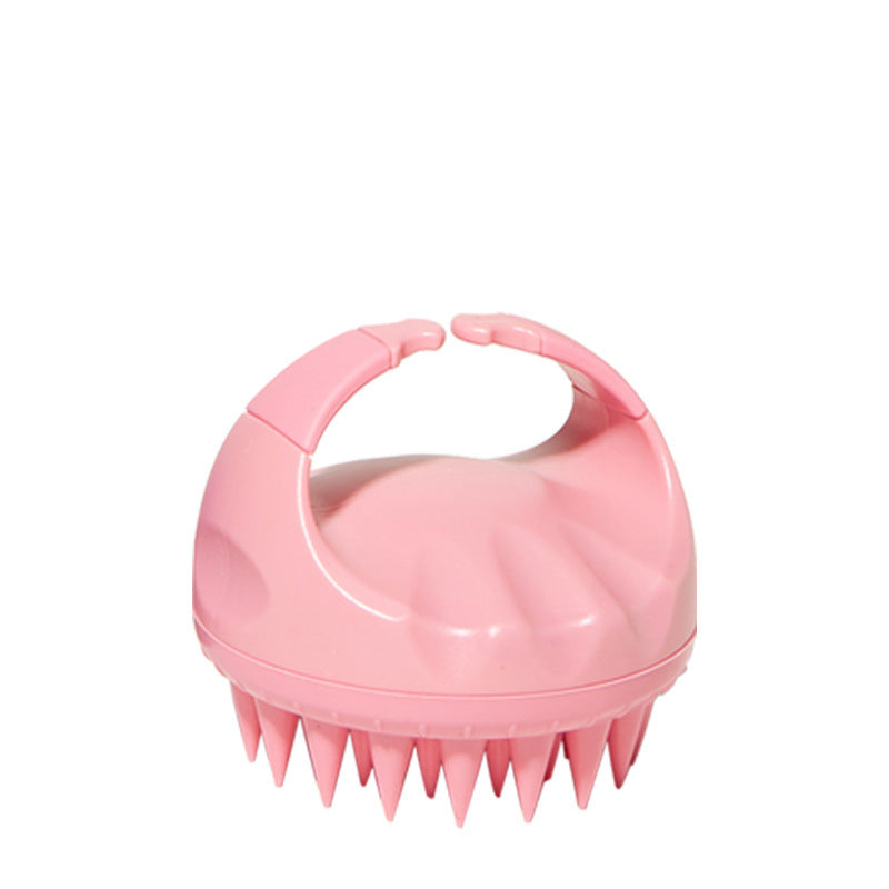 Silicone scalp brush in pink, angled view showing the bristles